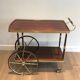 Mahogany and brass rolling table in the style of Maison Jansen.