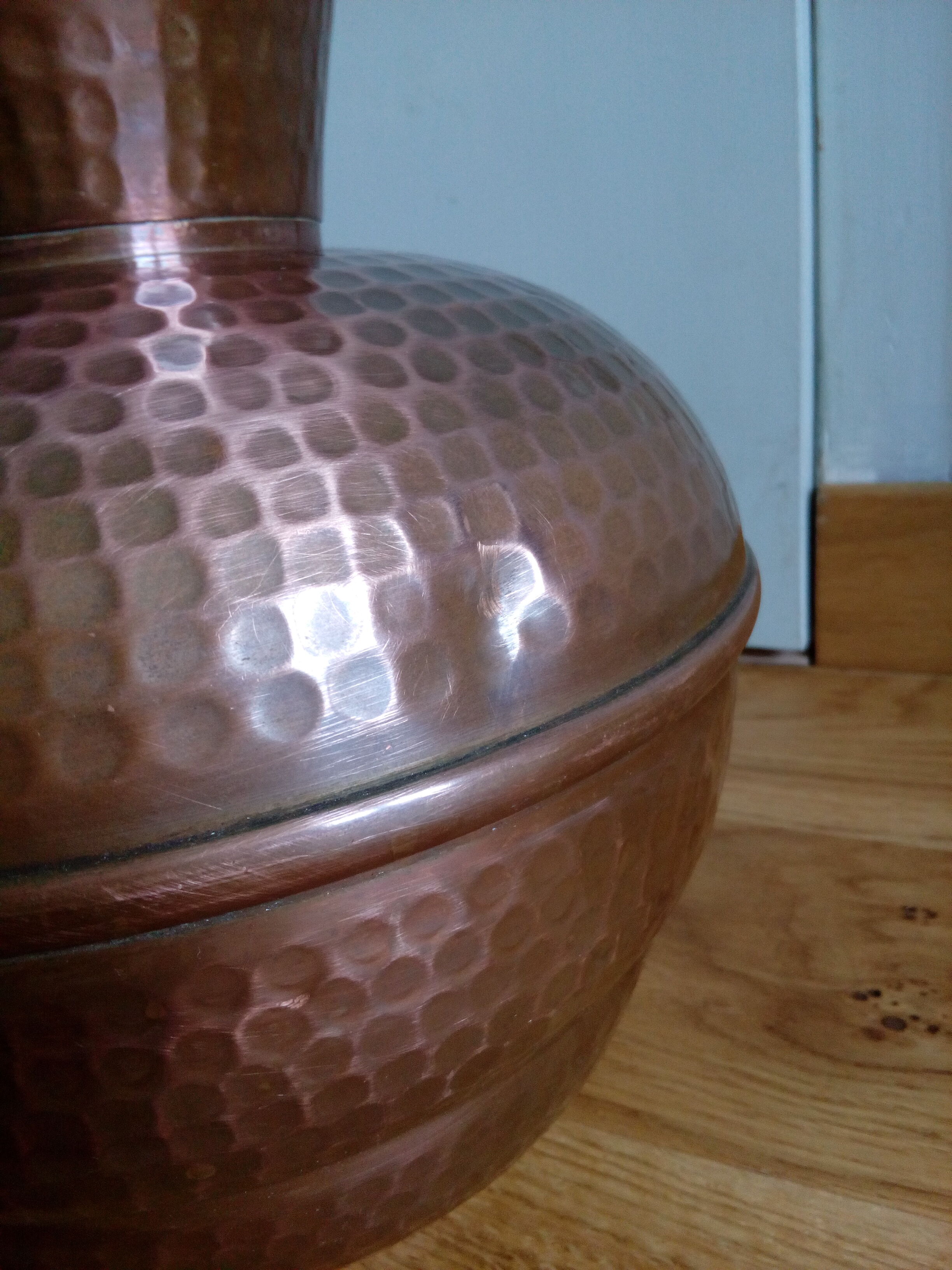 Dented copper vase or jug