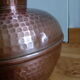 Dented copper vase or jug