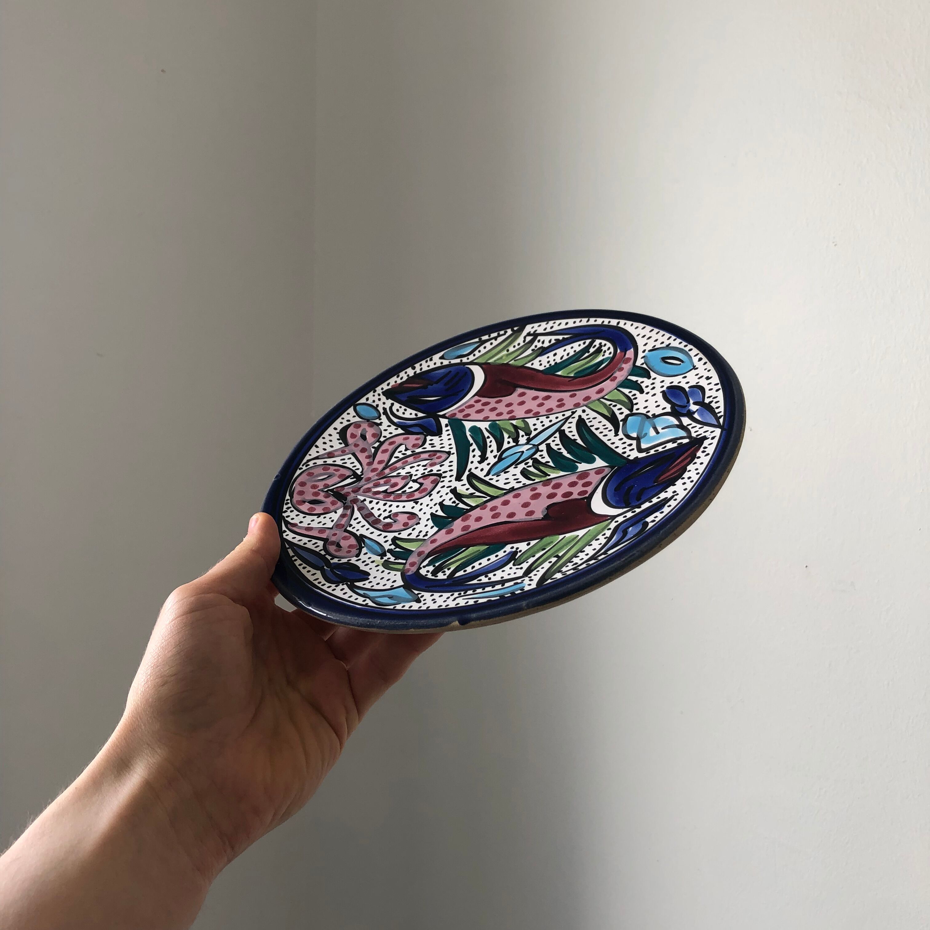 4 colorful flat plates with a fish pattern