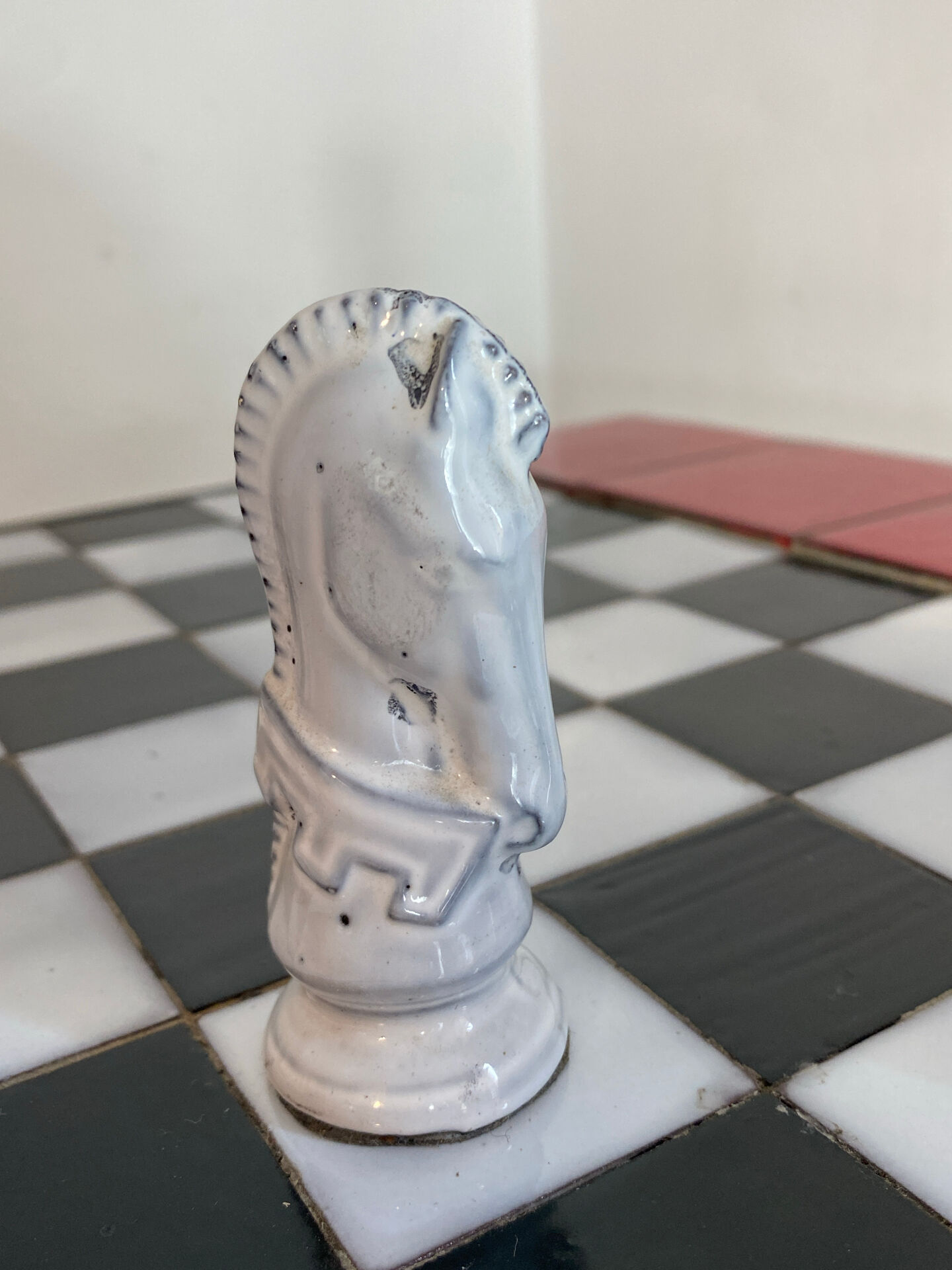 Chess set with ceramic board and pieces.