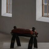 Dark red upholstered camel saddle stool, 20th century, North Africa.