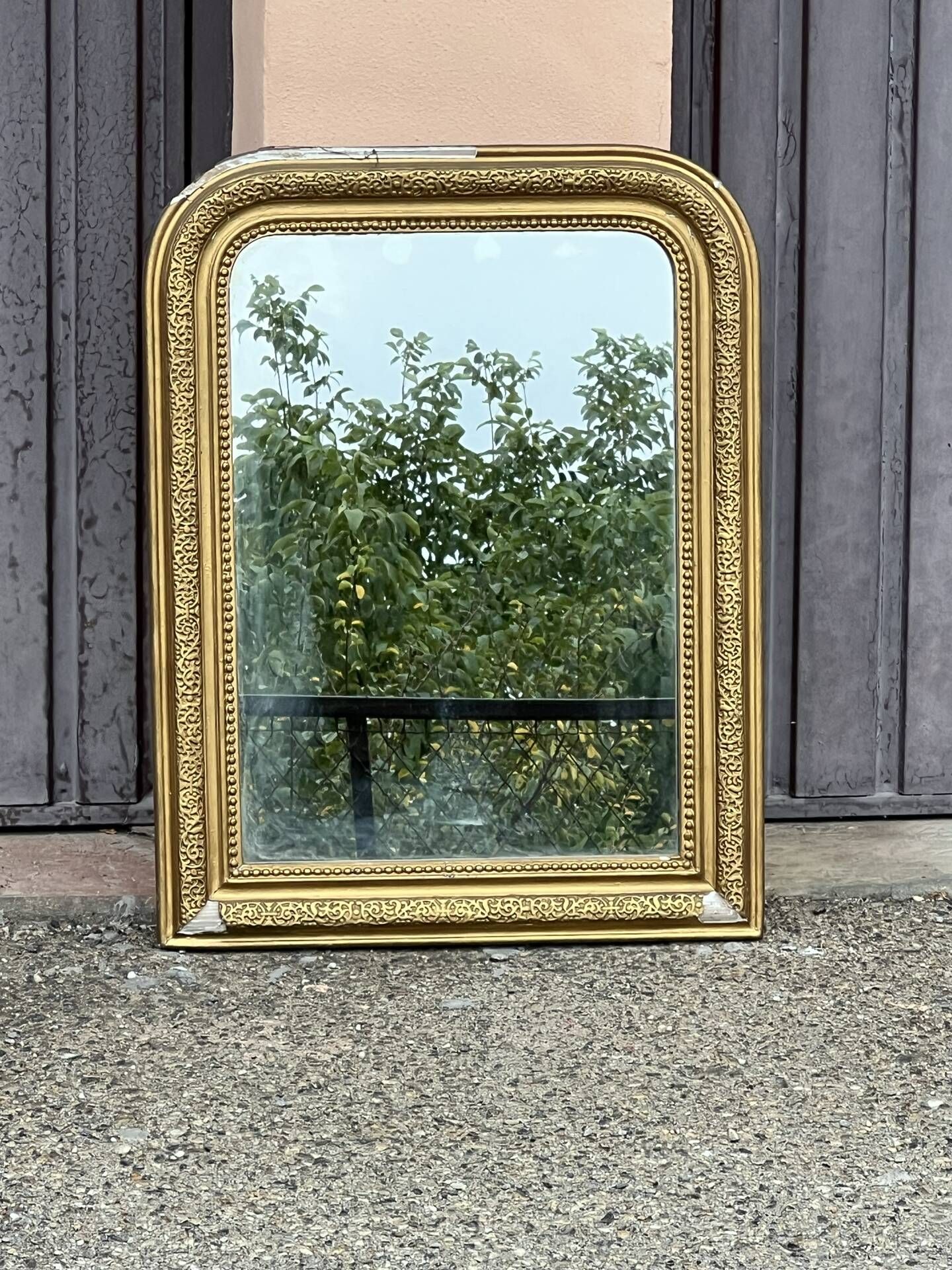 Louis Philippe mirror in gilded wood with an openwork frieze and mercury glass.
