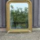 Louis Philippe mirror in gilded wood with an openwork frieze and mercury glass.