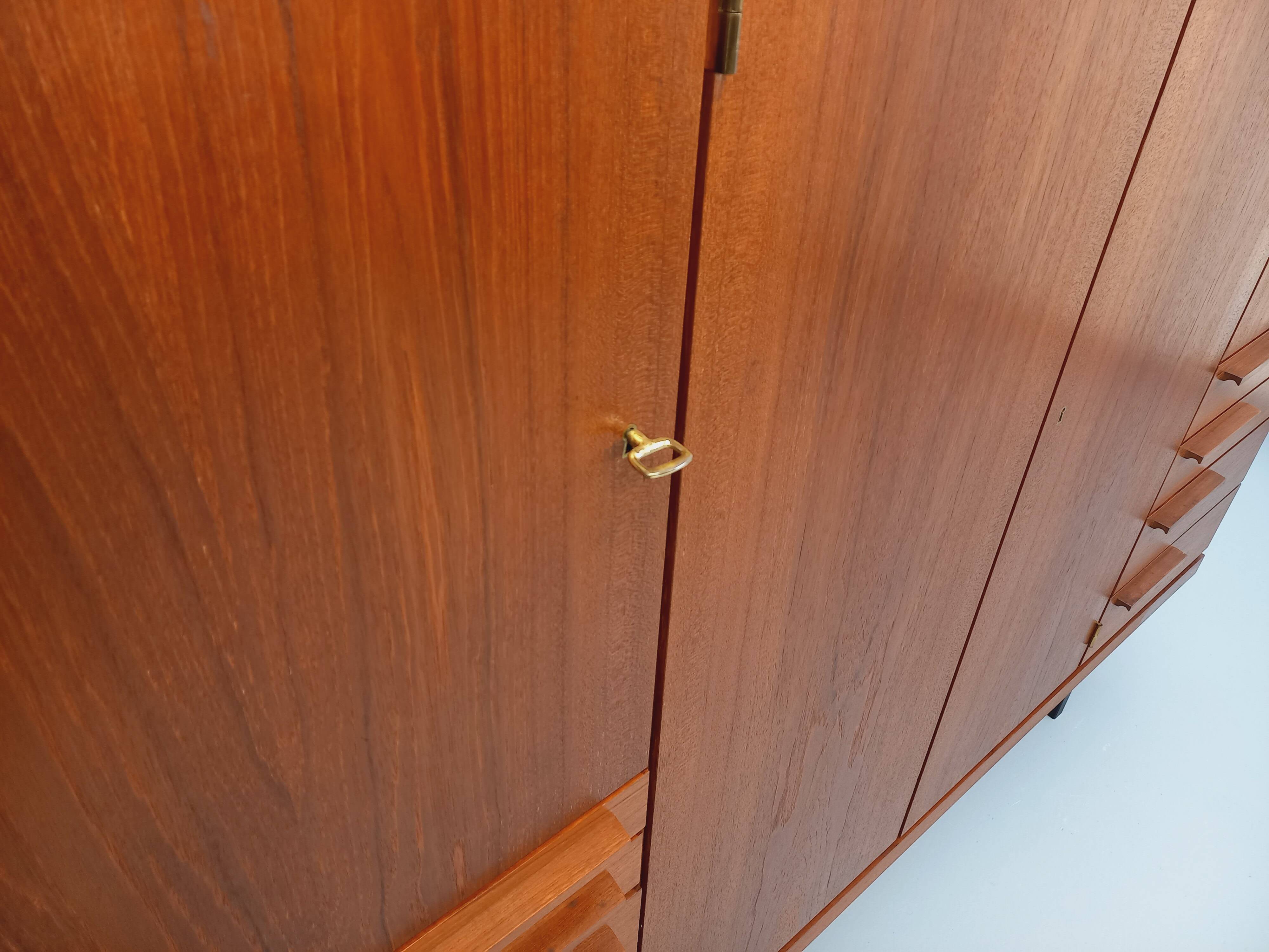 High Scandinavian modernist vintage sideboard in teak and black metal.