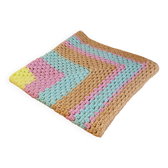 Vintage pastel crochet blanket for children.