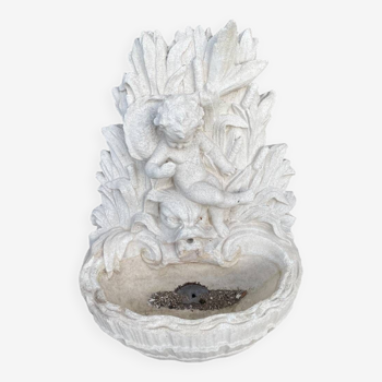 Large white stone wall garden fountain basin surmounted by a toddler and a dolphin