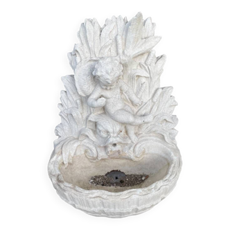 Large white stone wall garden fountain basin surmounted by a toddler and a dolphin