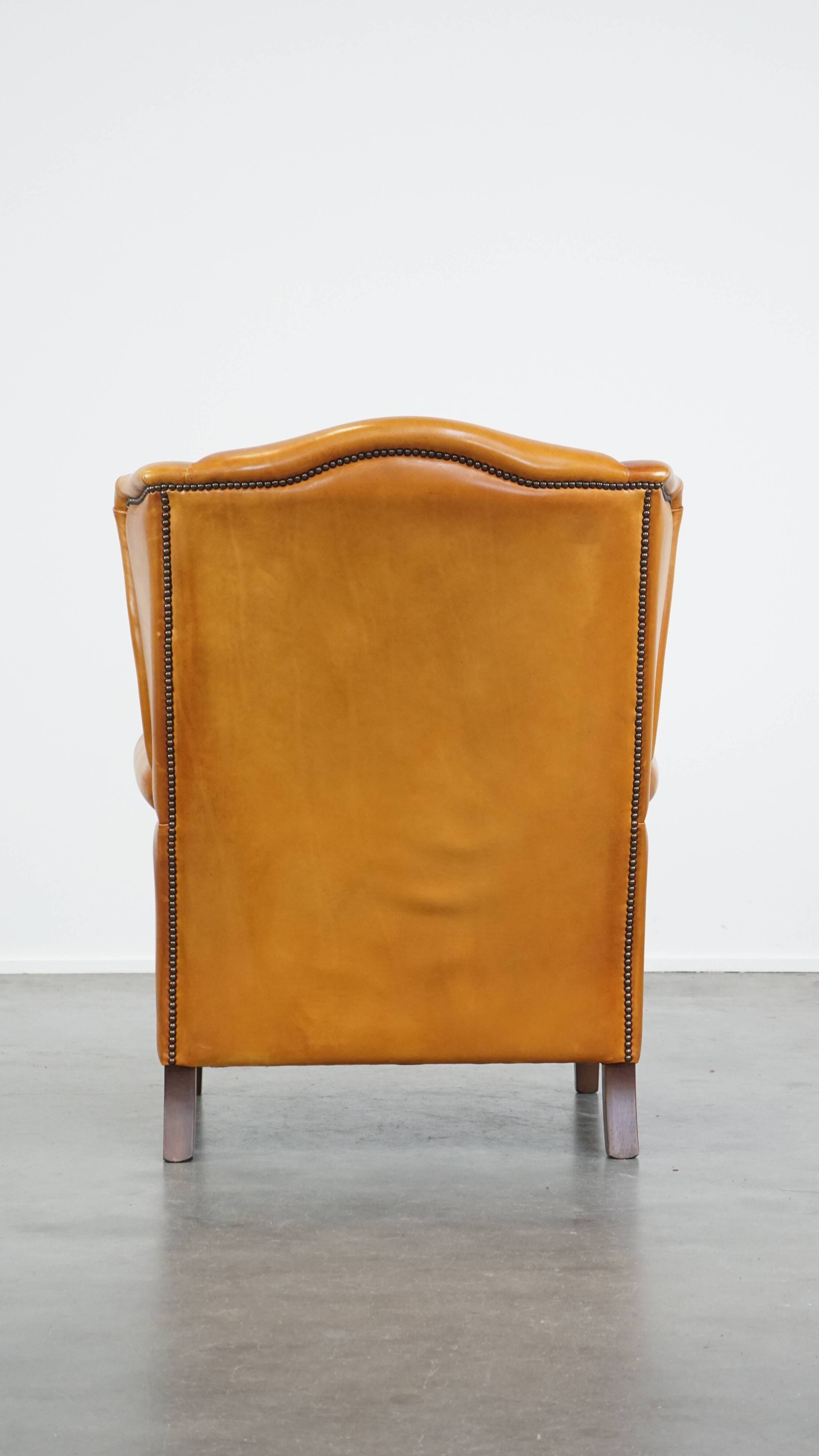Cow leather wingback chair finished with decorative nails