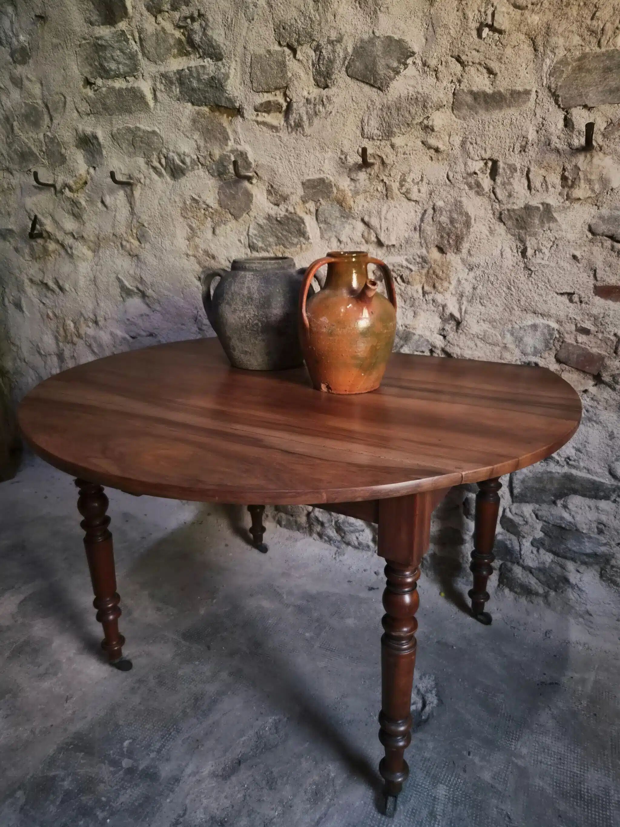 Antique drop-leaf dining table in walnut, France, circa 1900.