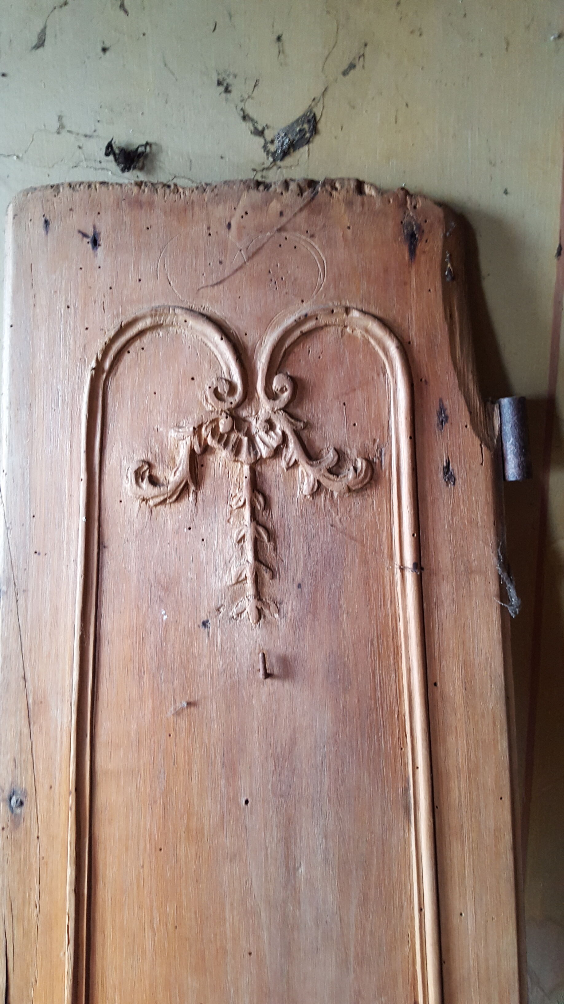 Wearing old 18th century decoration carved with flowers and foliage