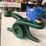 Art Deco candlestick in green and gold earthenware.