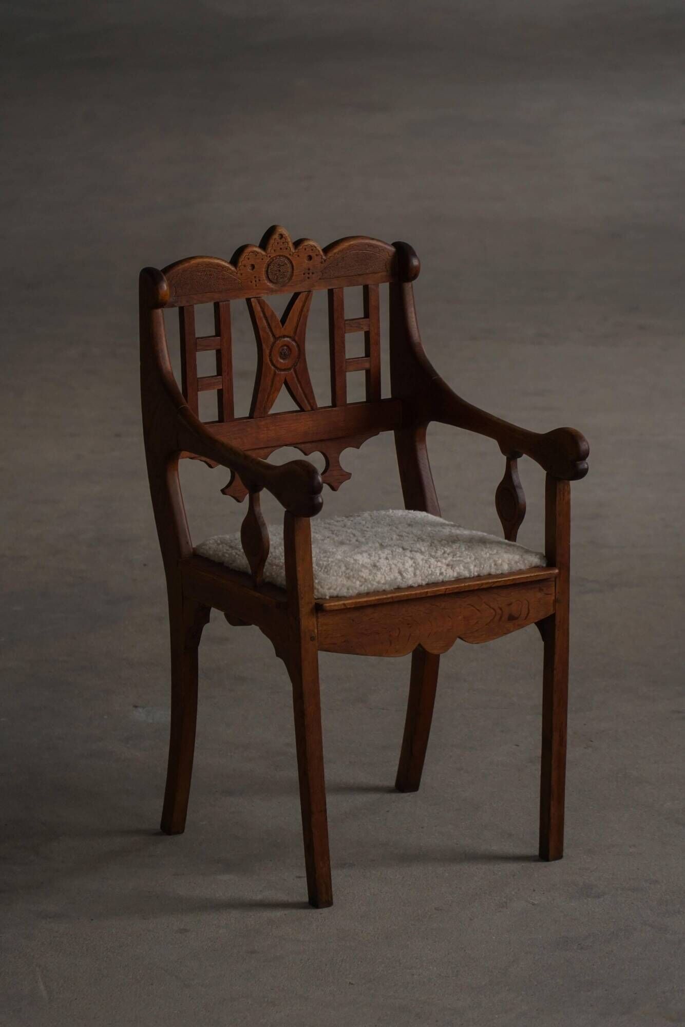Danish popular art armchair in oak with a lambswool seat, early 20th century, 1930s.