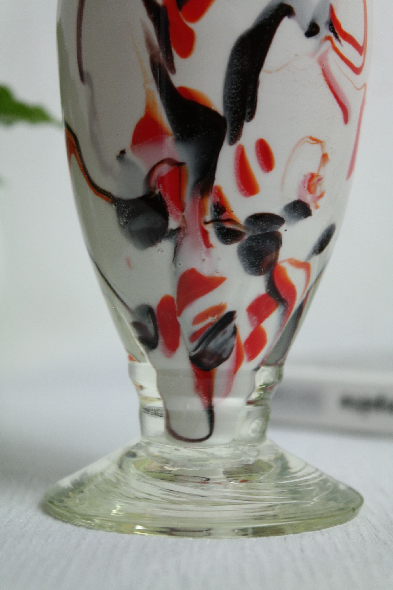 Corolla vase in white opaline with orange-brown patterns.