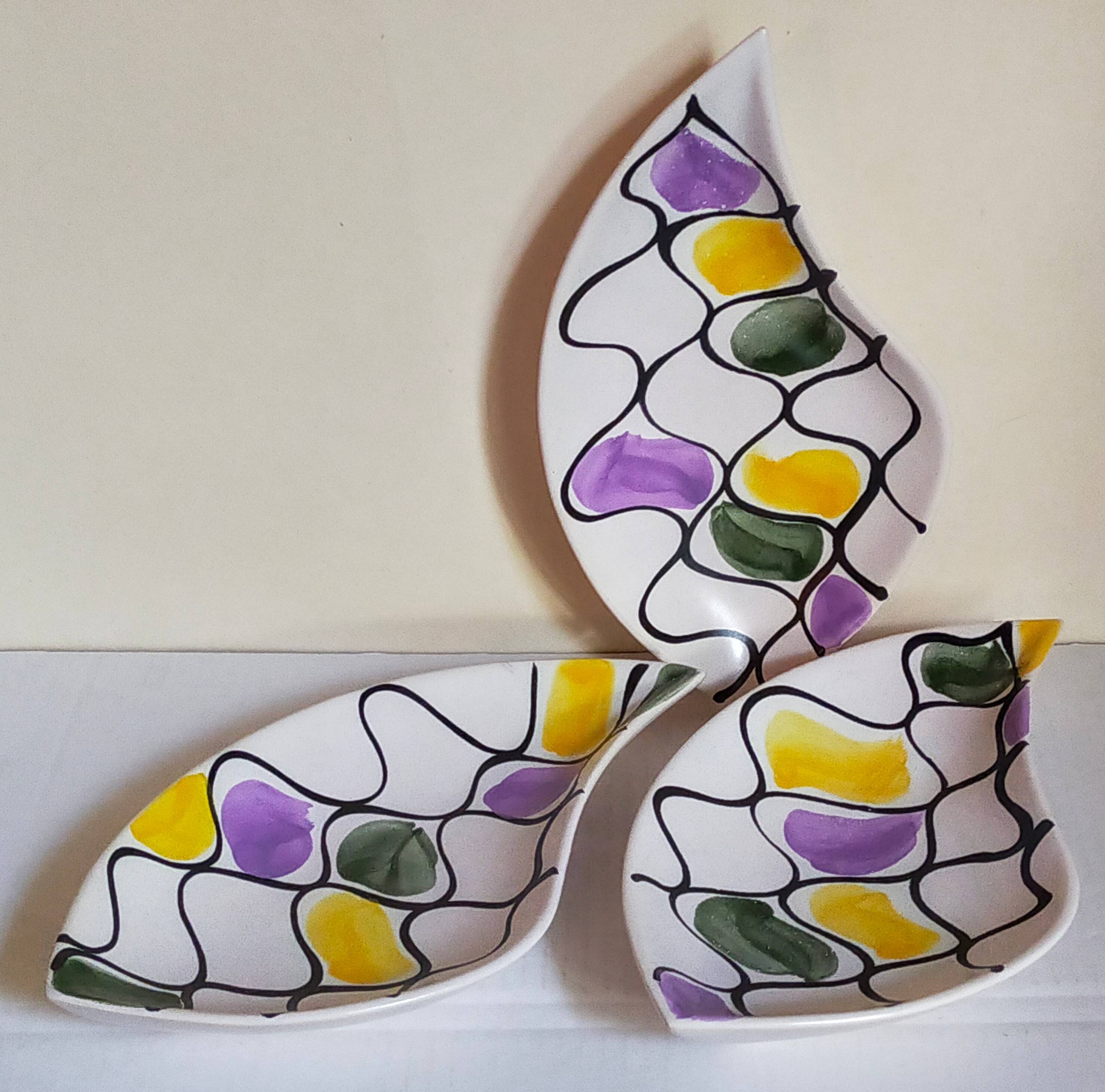 Three vintage free-form ceramic ravine dishes from the 1950s