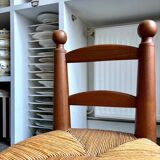 Brutalist low chair in dark wood and straw no. 3