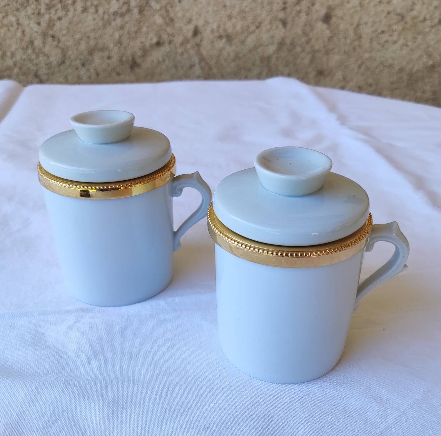 2 white and gold Limoges porcelain tea cups