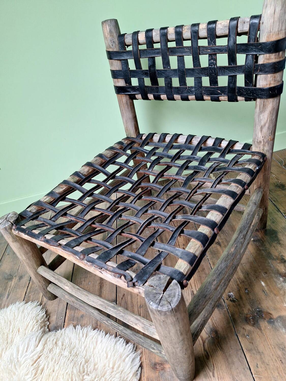 Vintage armchair in woven leather and wood