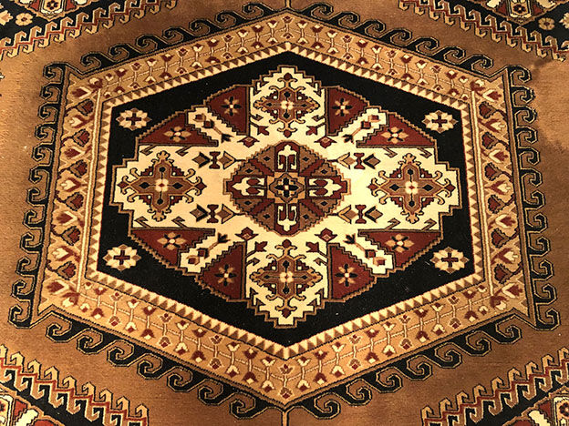 Wool carpet with oriental decoration on a brown background