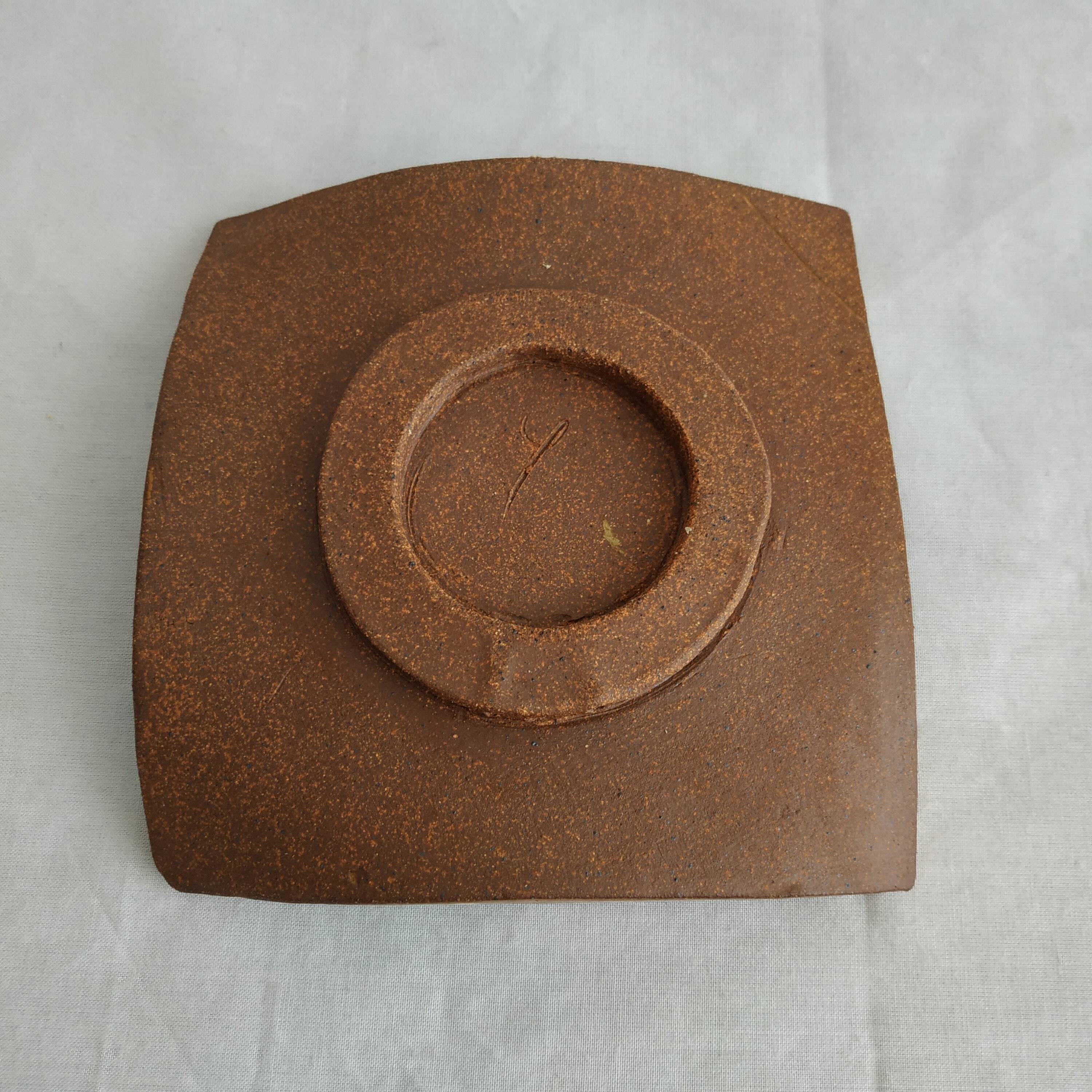 Two terracotta bowls with ethnic decoration and vintage signature.