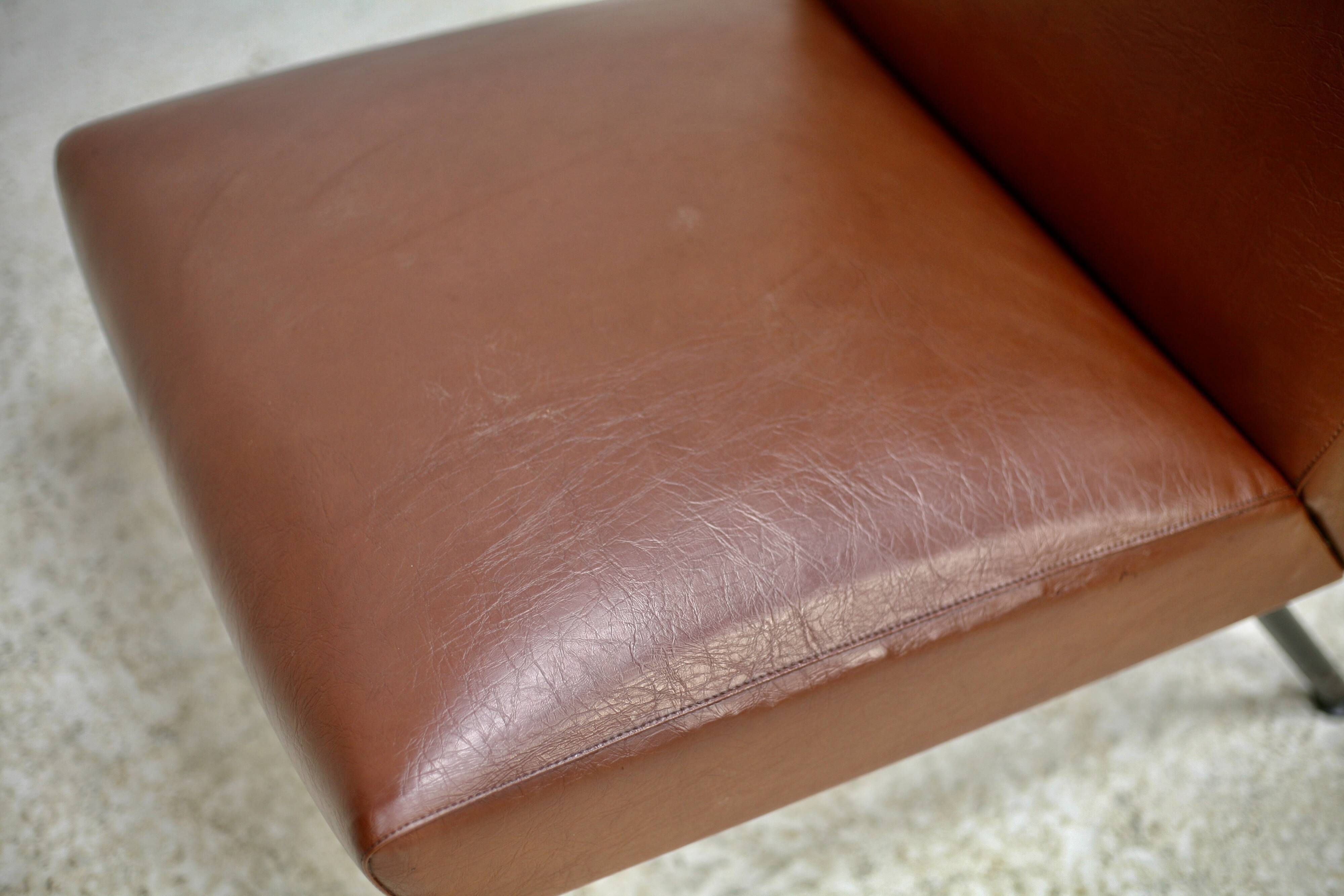 Low chair, circa 1950. Brown imitation leather.