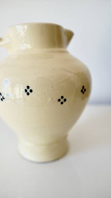 Vintage butter yellow ceramic pitcher in rustic style