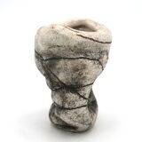 Ceramic vase sculpture decorated with faces and featuring a hole, 1980s.