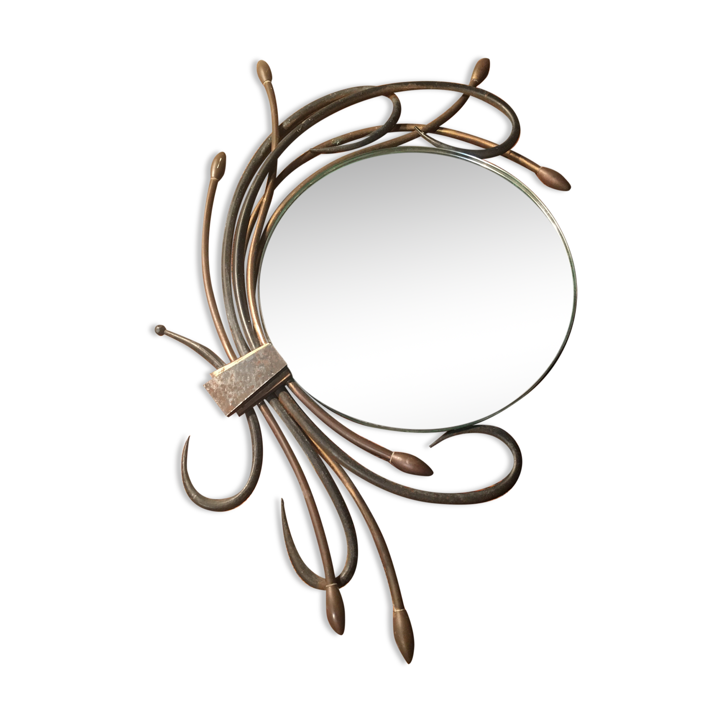 Round mirror surrounded by art deco style metal plants