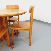 Suite of a round table with extension and 4 vintage pine chairs from the 60s and 70s