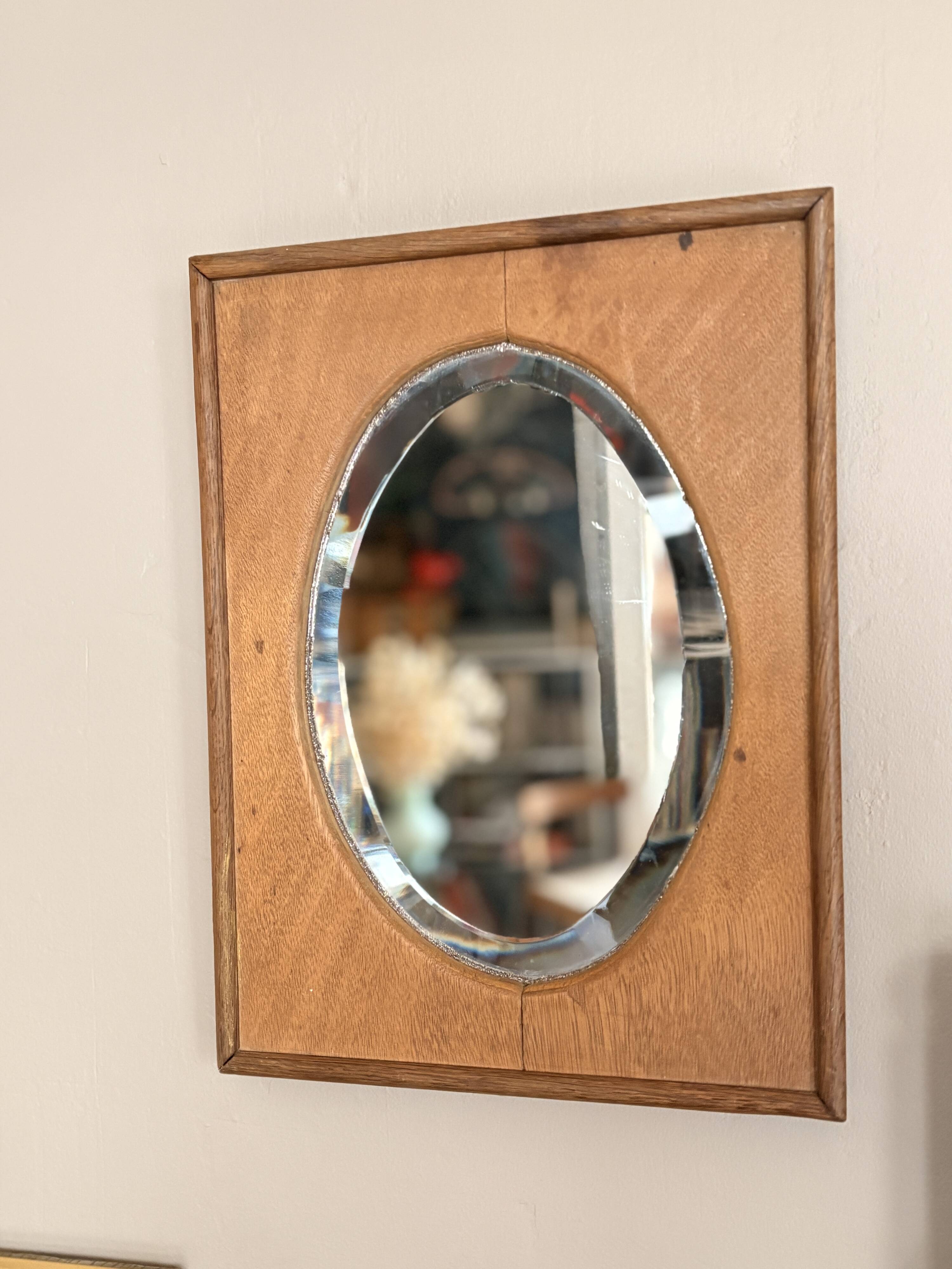 Bevelled oval mirror on oak frame