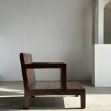 Small low armchair in varnished brown wood