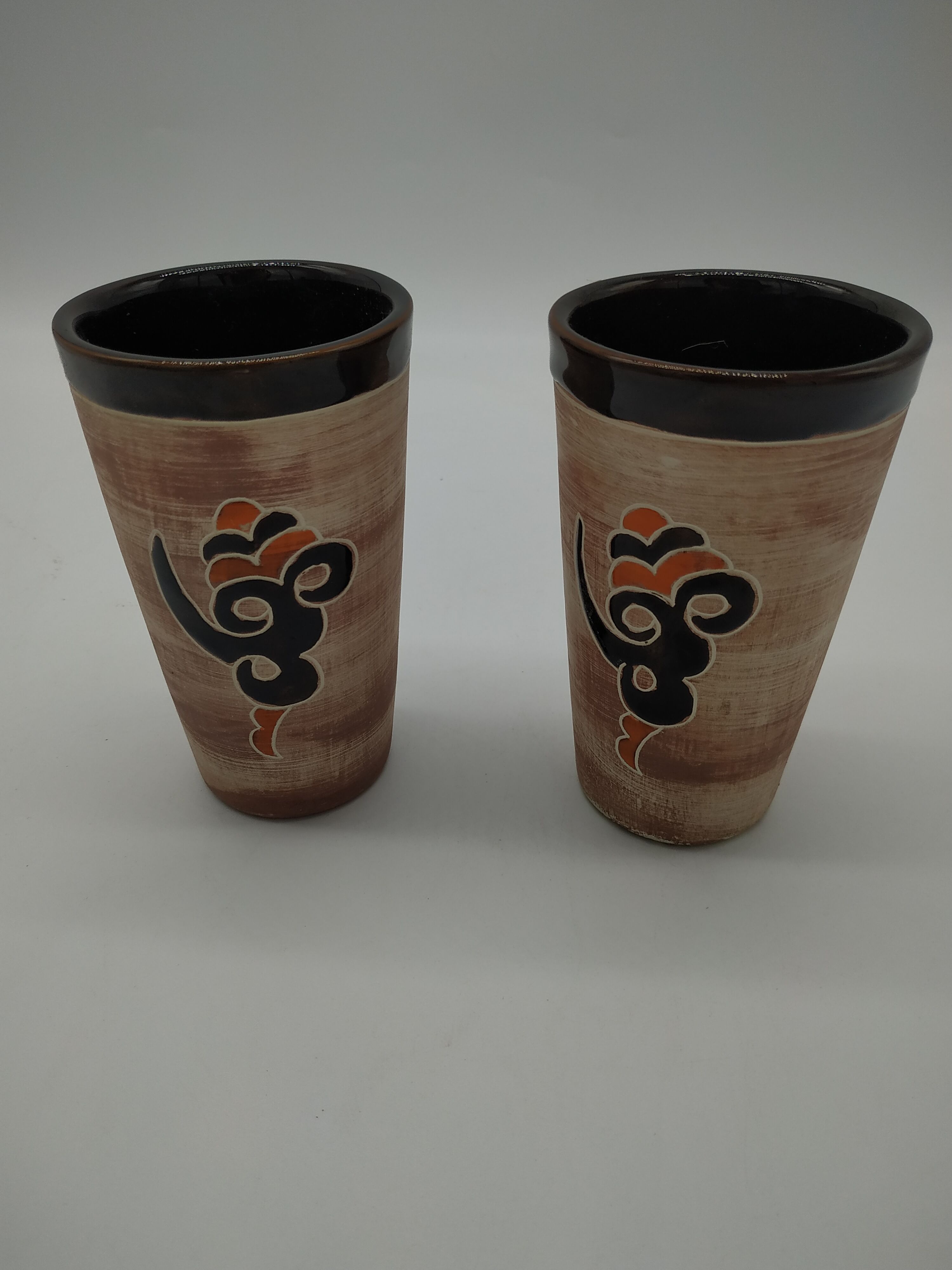 Pair of vintage enamelled terracotta mugs