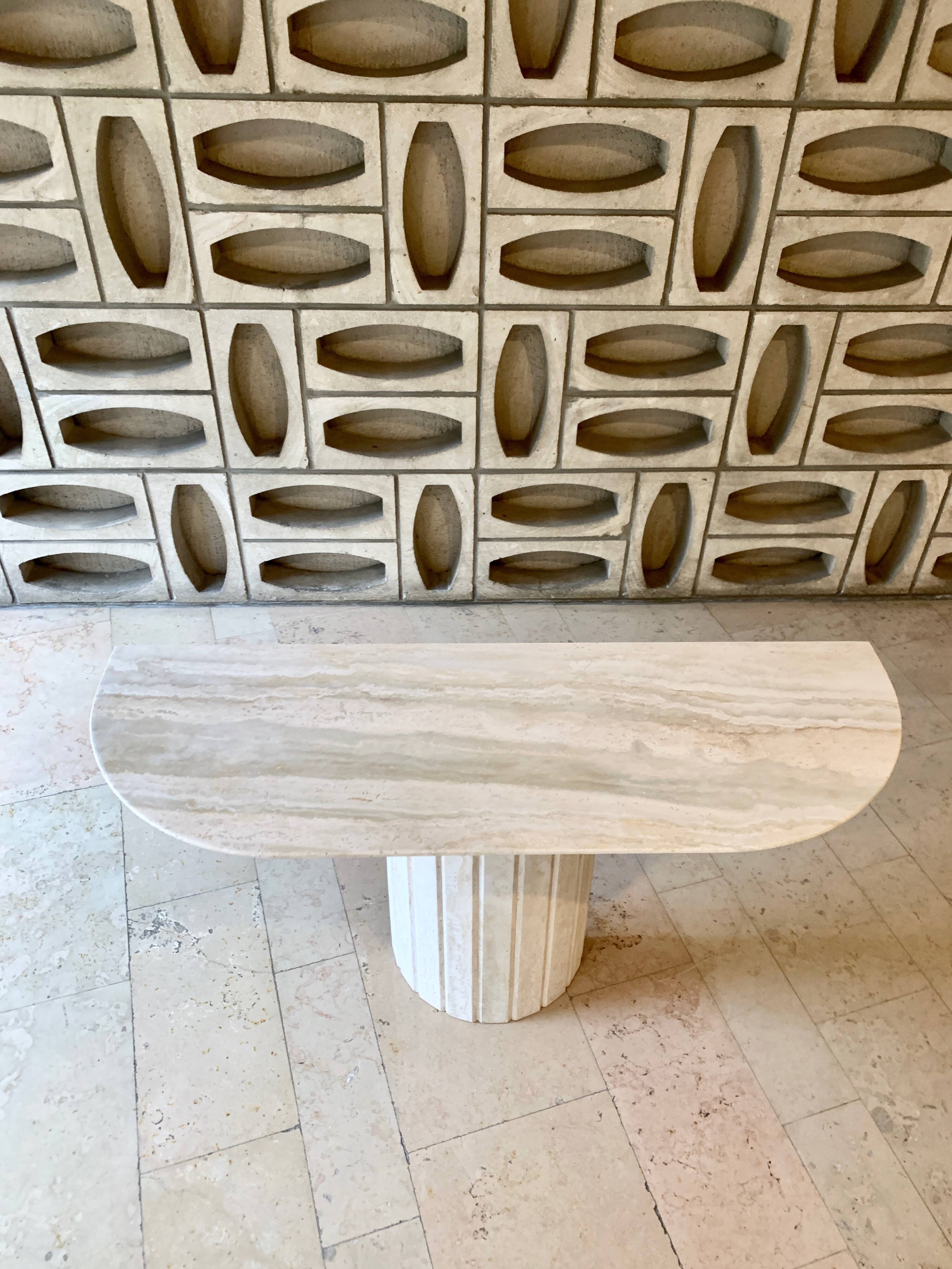Travertine console with canted foot
