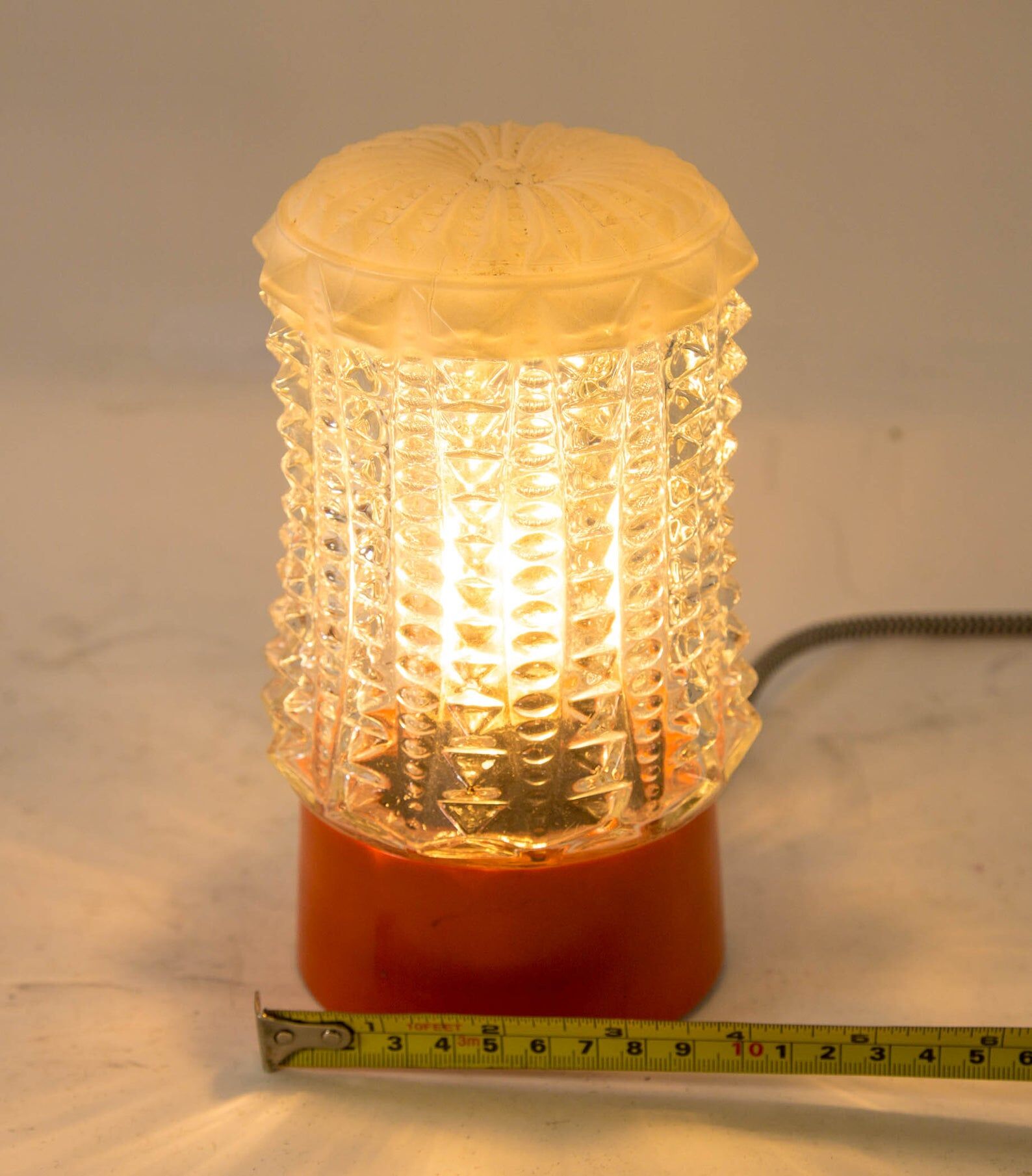 Built-in glass dome and vintage round orange base from the 70s