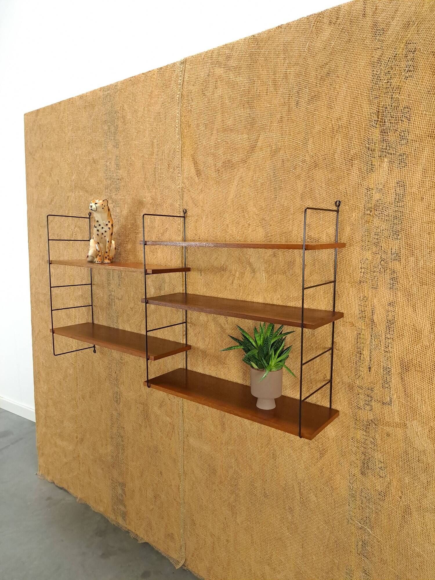 Wall rack with shelves and steel holders, dark wall system