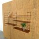 Wall rack with shelves and steel holders, dark wall system