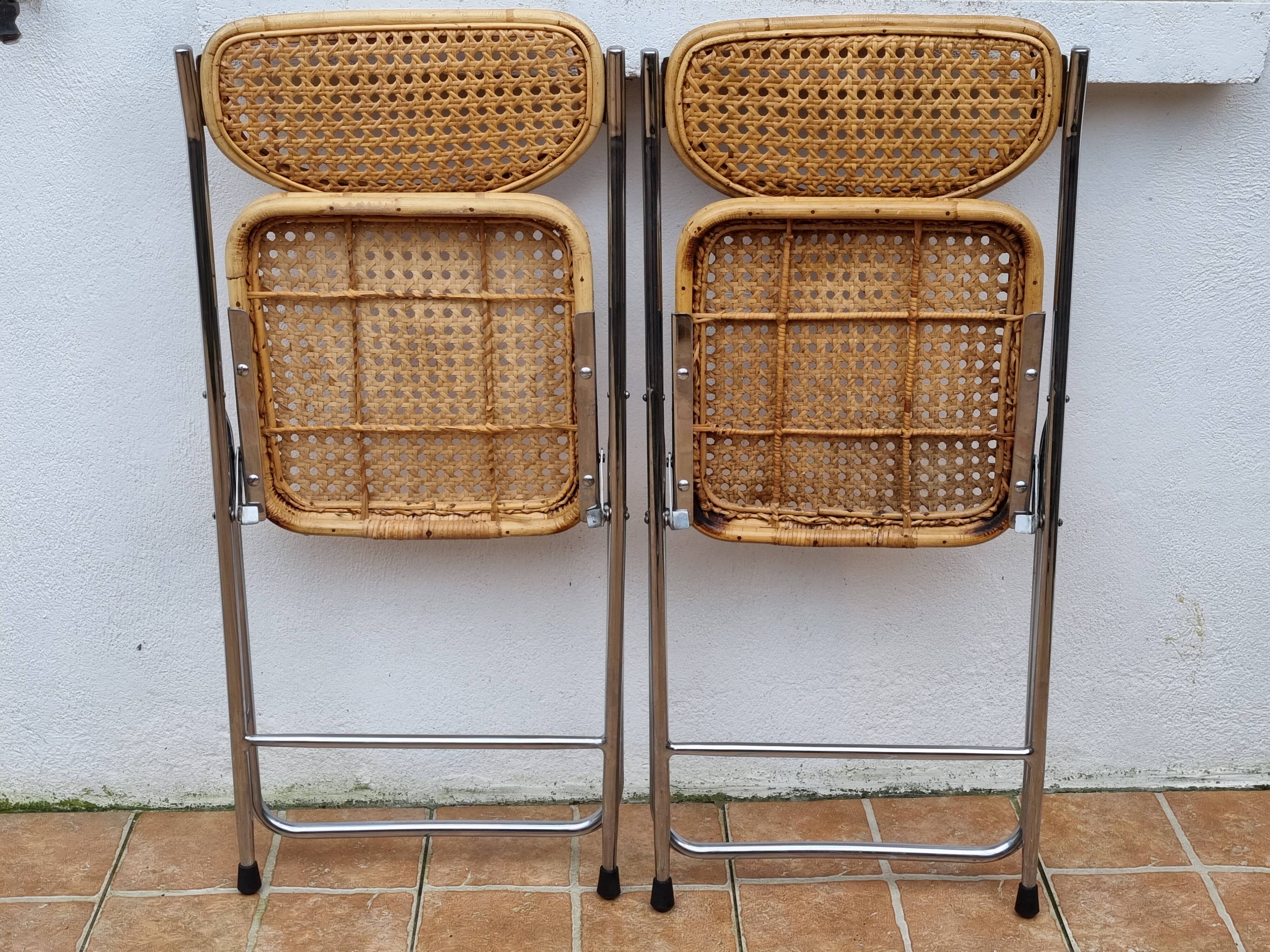 Pair of vintage metal and cane folding chairs