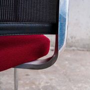 Set of 4 cantilever chairs with burgundy seat and mesh backrest.