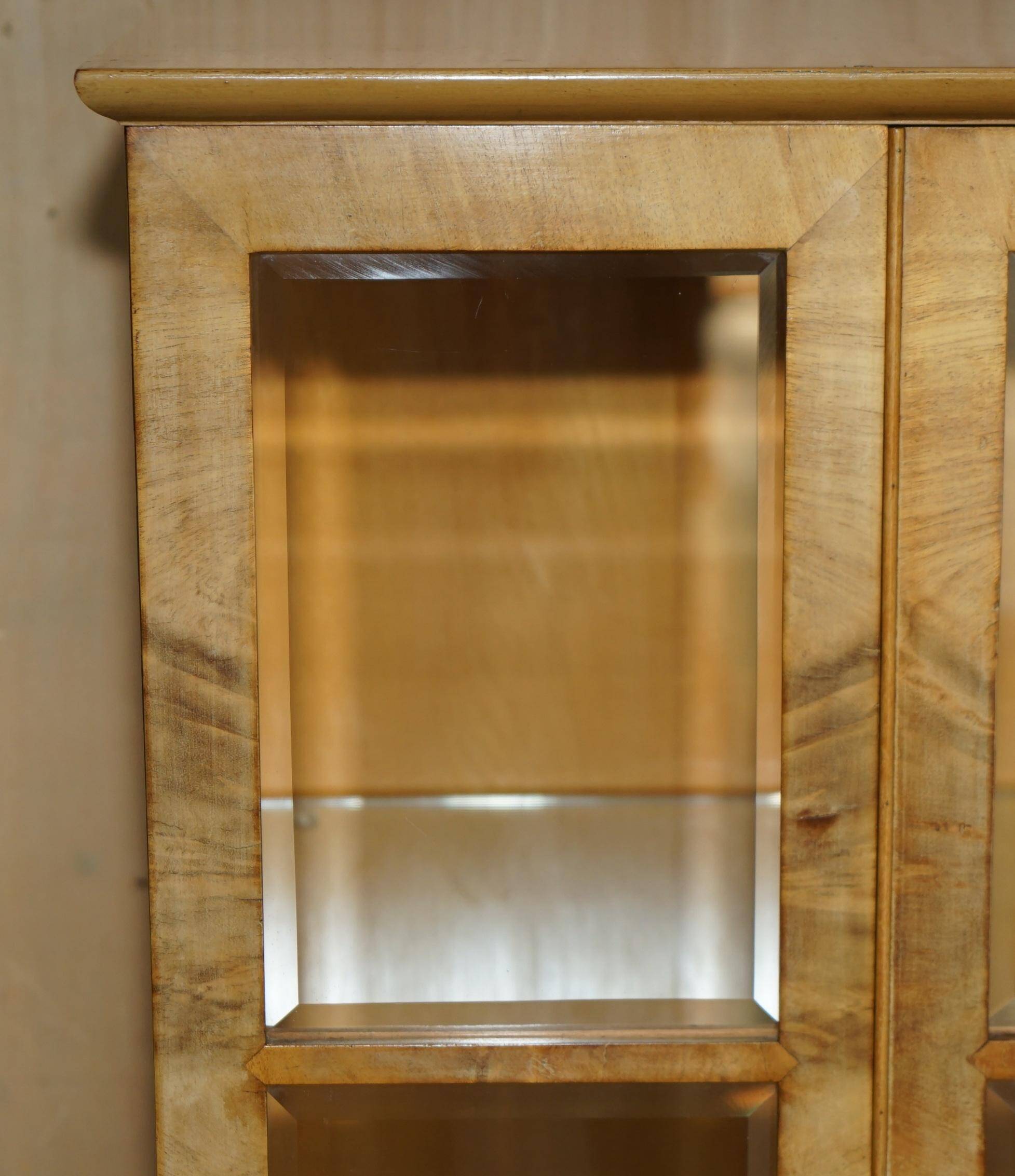 Pair of Art Deco display cabinets circa 1920 in light walnut with Cabriolet legs.