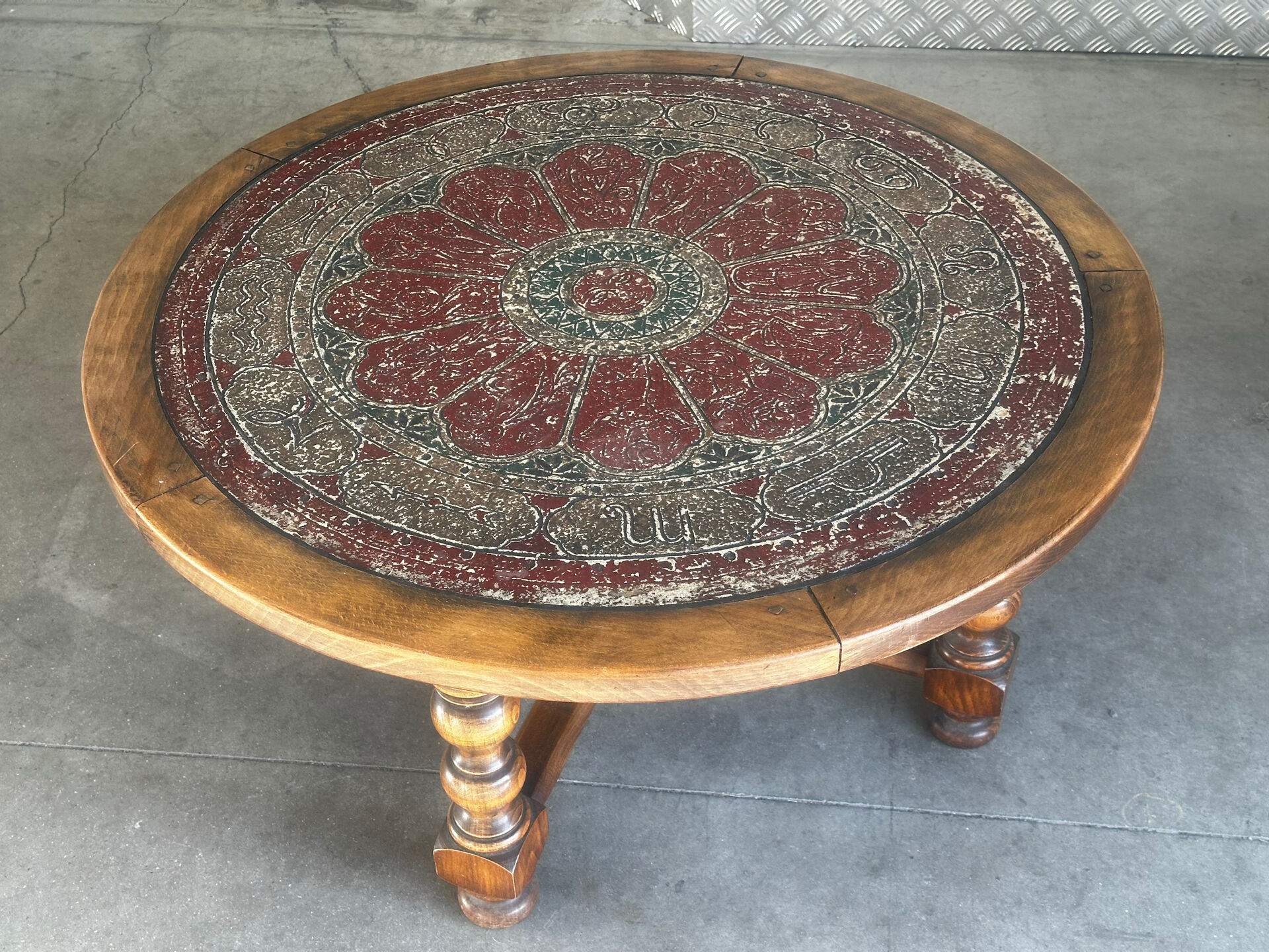 Vintage coffee table in turned wood and leather with astrological decoration.