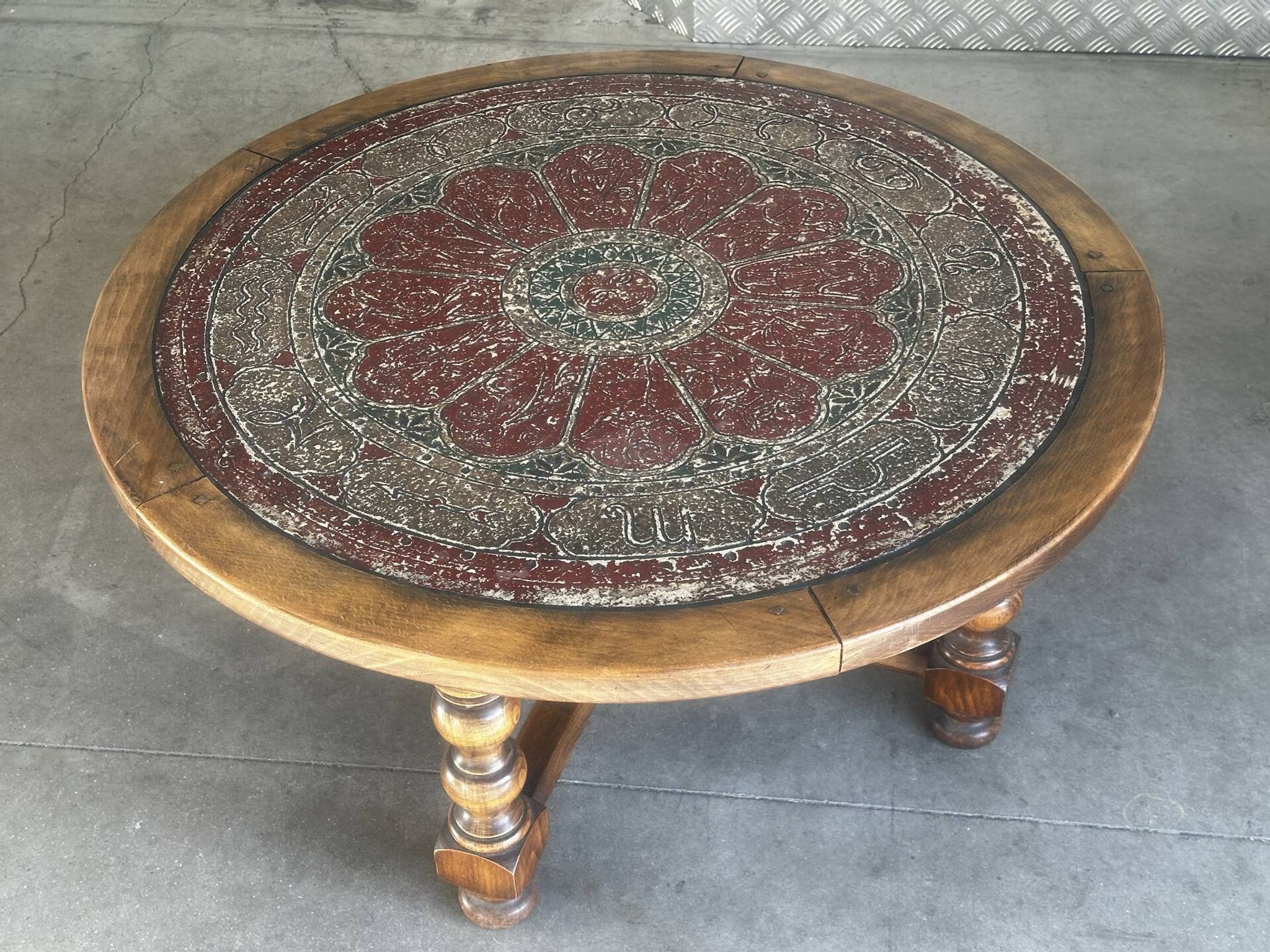 Vintage wooden turned coffee table with leather and astrological decoration.