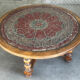 Vintage coffee table in turned wood and leather with astrological decoration.