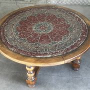 Vintage wooden turned coffee table with leather and astrological decoration.