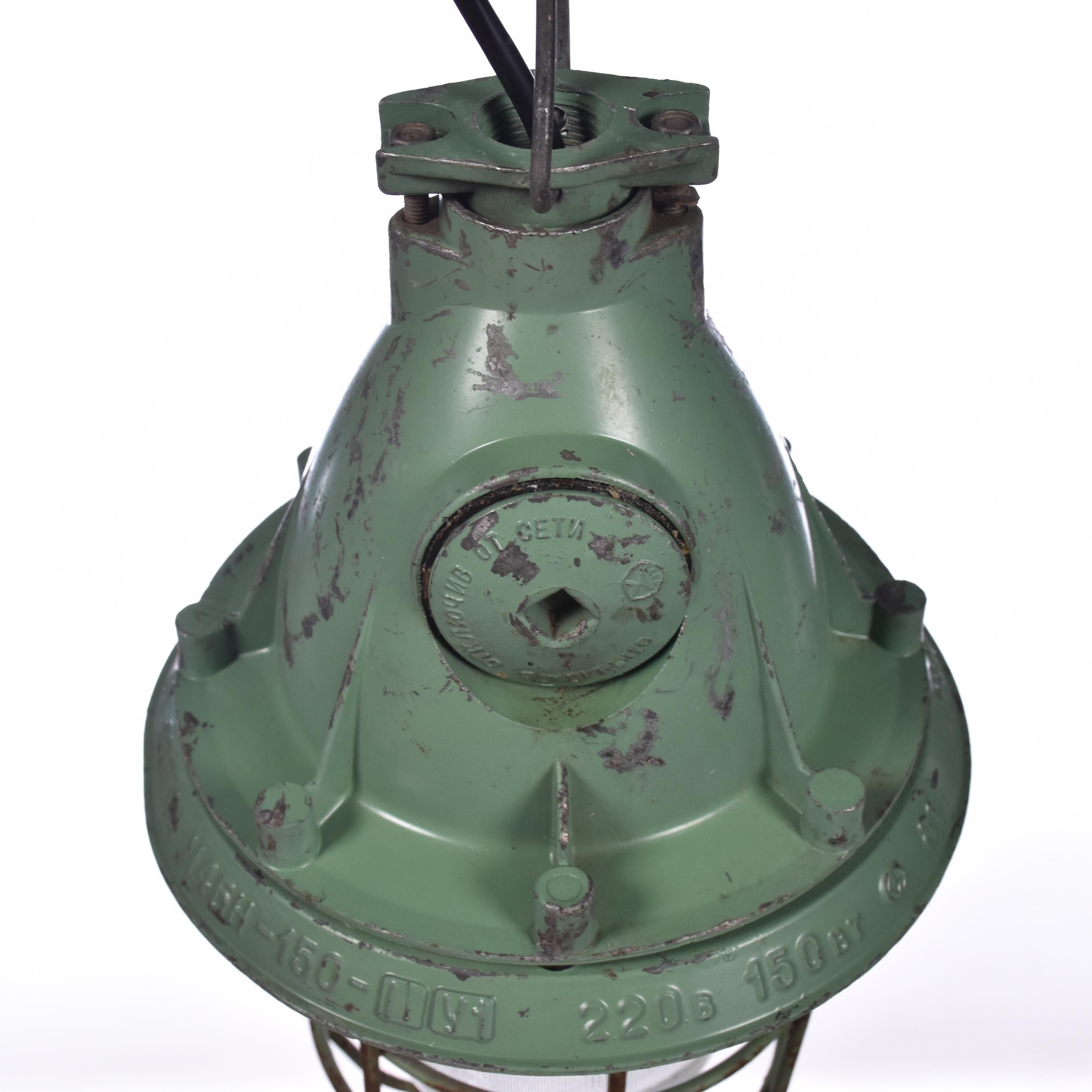 Industrial caged green lamp