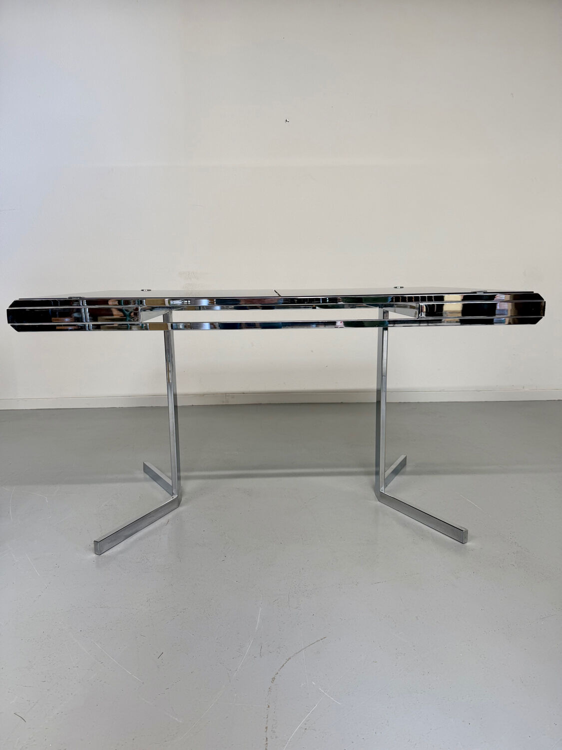Smoked glass dining table with chrome legs, 1970s design by Roche Bobois.