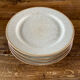 Four beige speckled plates
