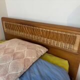 Vintage single bed made of rattan from the 1970s with a mattress.
