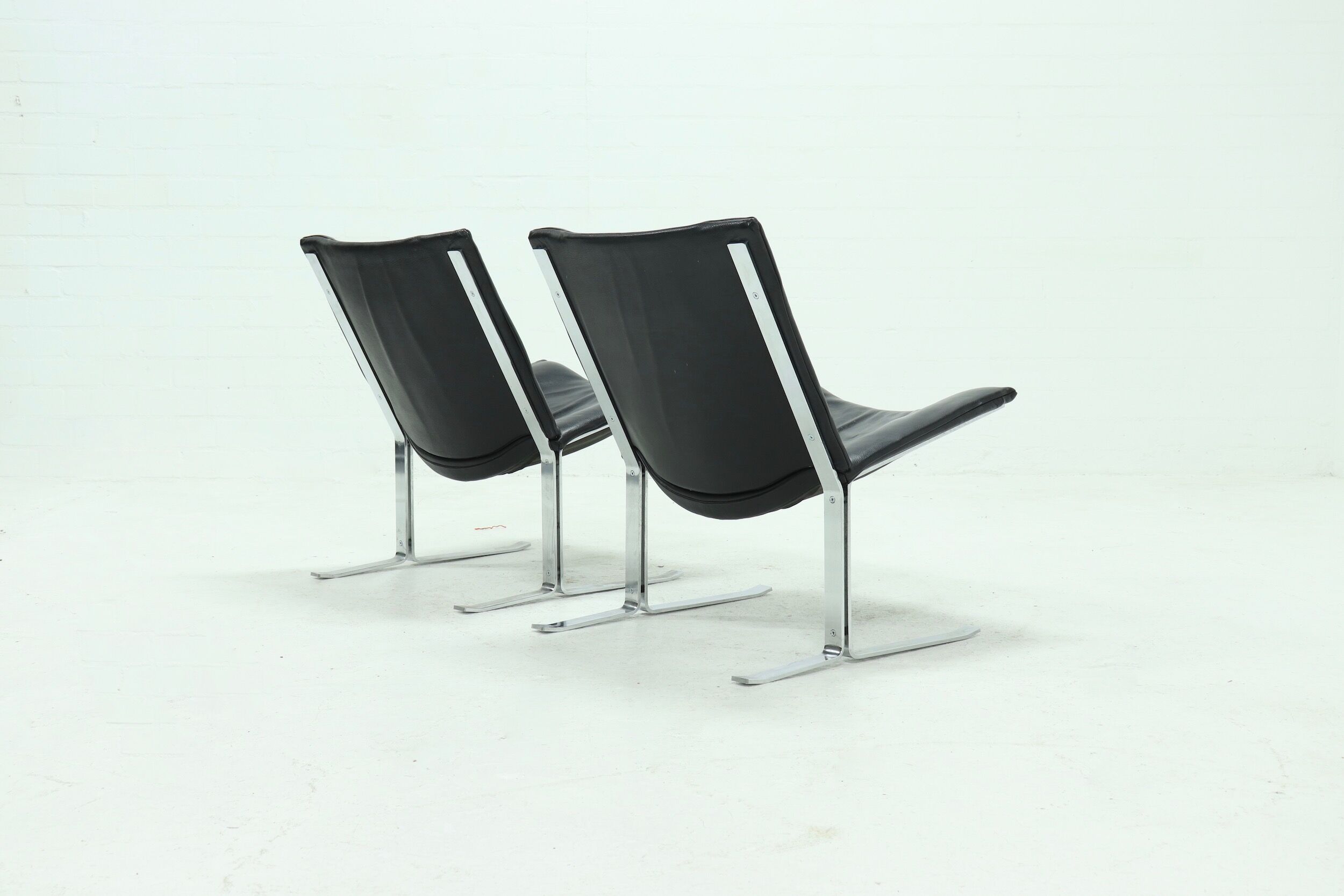 Set of 2 Danish lounge chairs by Kebe Møbler model Eagle with black leather.