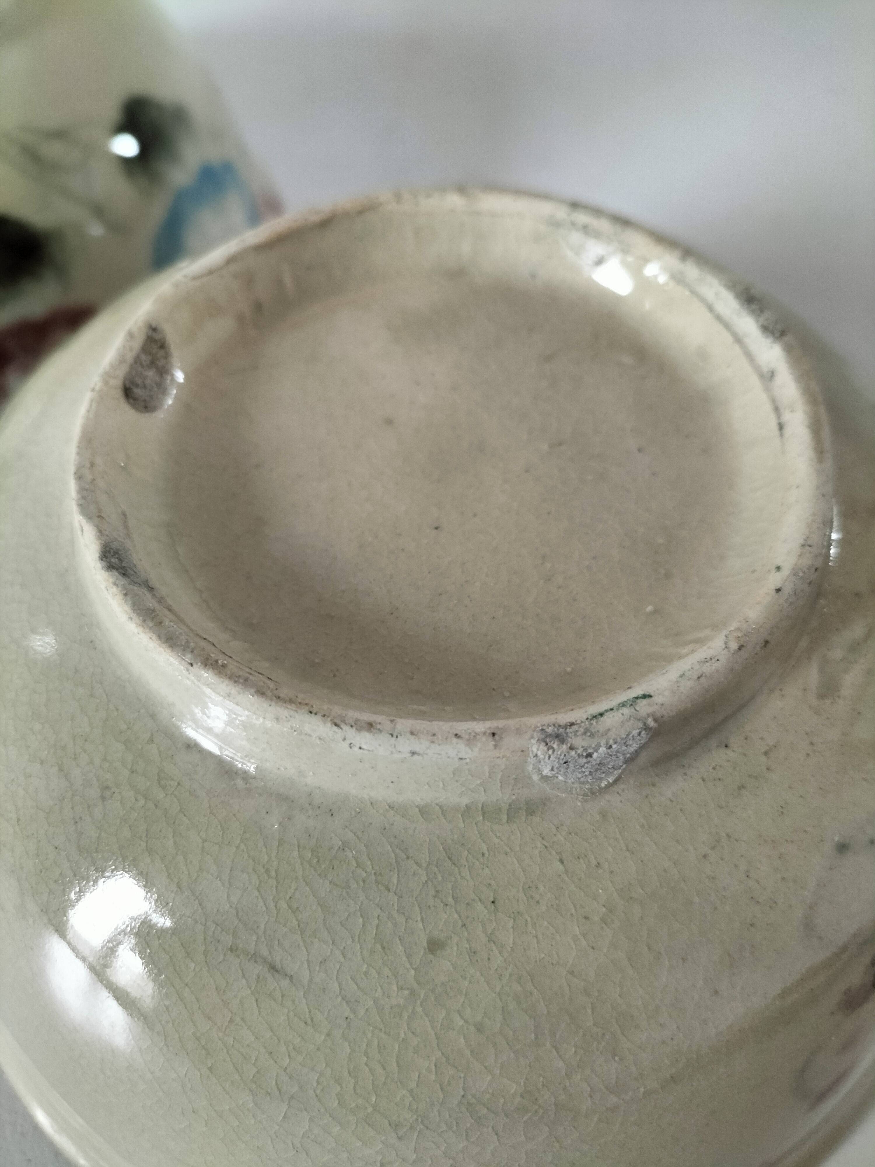 Two large vintage bowls in pastel decor on mini pedestals.