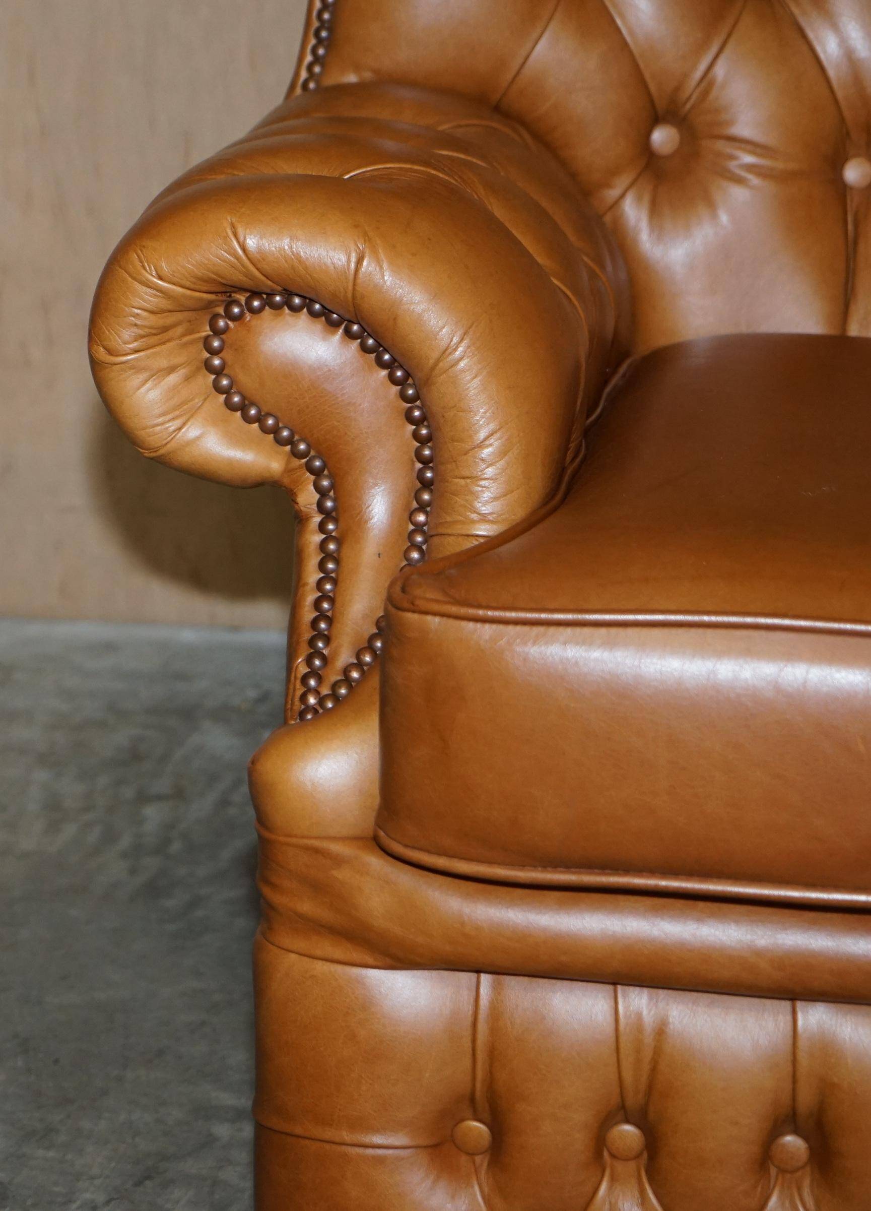 Small Chesterfield leather sofa with a high back.
